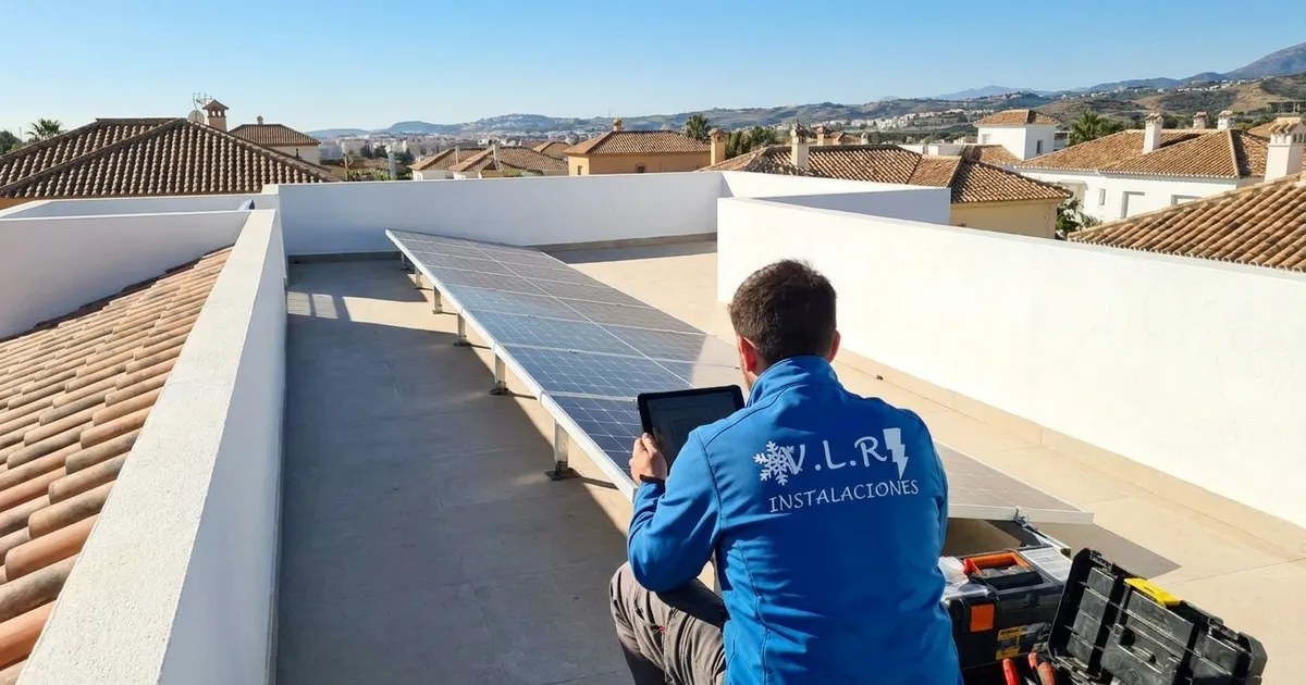 VLR Instalaciones electrician checking the orientation of solar panels on the roof of a home in Málaga