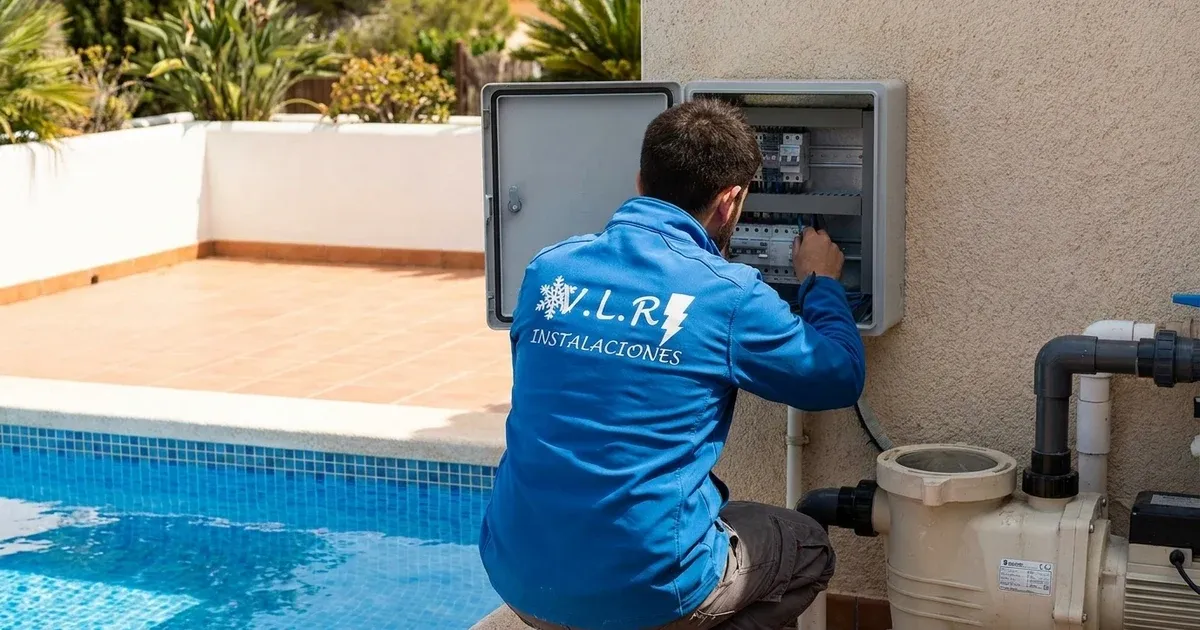VLR Instalaciones electrician working on the weatherproof enclosure beside a swimming pool filtration pump